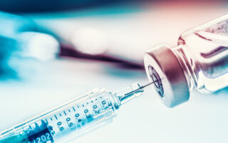 Close-up medical syringe with a vaccine.