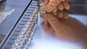 Vials being aligned in tray for pharmaceutical product development