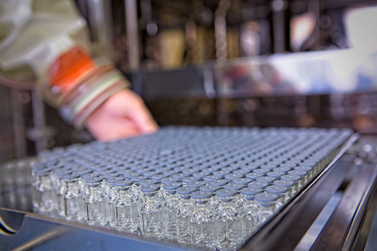 Vials in tray being loaded into lyophiliser during peptide manufacturing